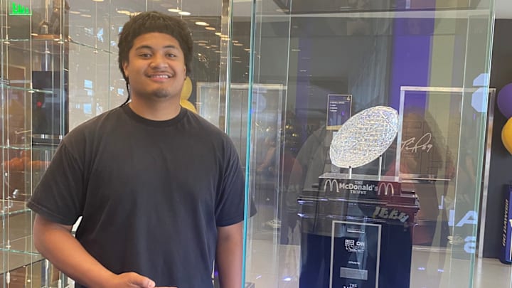 Esun Tafa, recruit from Utah, checks out the UW trophy case on a summer visit. 