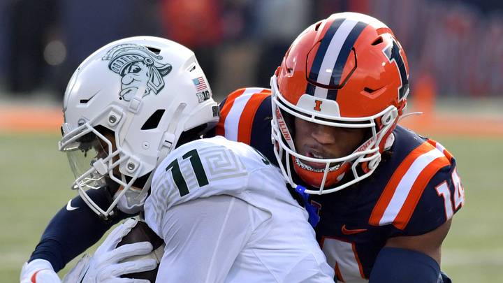 Nov 16, 2024; Champaign, Illinois, USA; Illinois Fighting Illini defensive back Xavier Scott (14) tackles Michigan State receiver Aziah Johnson (11) during the first half at Memorial Stadium. Mandatory Credit: Ron Johnson-Imagn Images