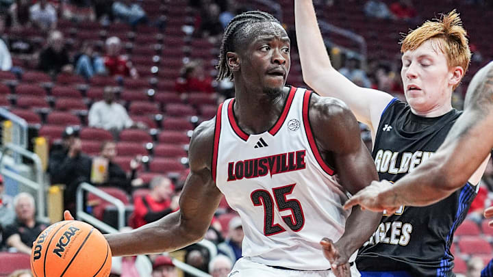 Louisville Cardinals forward Aboubacar Traore (25) looks to pass around Spalding University's Caden Bradford (0) at the KFC Yum! Center in Louisville, Kentucky Monday, Oct. 28, 2024. Louisville Cardinals forward Aboubacar Traore (25) looks to pass around Spalding University's Caden Bradford (0) at the KFC Yum! Center in Louisville, Kentucky Monday, Oct. 28, 2024.