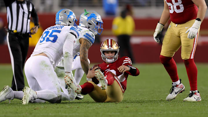 Dec 30, 2024; Santa Clara, California, USA; San Francisco 49ers quarterback Brock Purdy (13) is sacked by Detroit Lions safety Brian Branch (32) during the fourth quarter at Levi's Stadium. Mandatory Credit: Sergio Estrada-Imagn Images Dec 30, 2024; Santa Clara, California, USA; San Francisco 49ers quarterback Brock Purdy (13) is sacked by Detroit Lions safety Brian Branch (32) during the fourth quarter at Levi's Stadium. Mandatory Credit: Sergio Estrada-Imagn Images