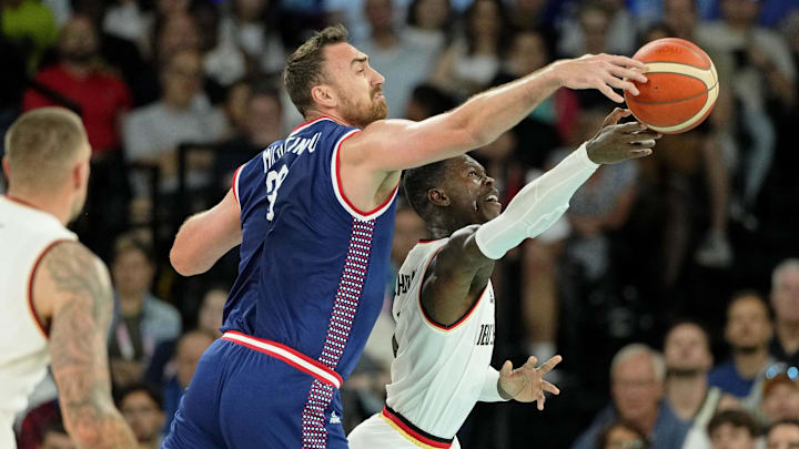 Aug 10, 2024; Paris, France; Germany point guard Dennis Schroder (17) reaches for the ball against Serbia centre Nikola Milutinov (33) in the men's basketball bronze medal game during the Paris 2024 Olympic Summer Games at Accor Arena. Mandatory Credit: Kyle Terada-Imagn Images