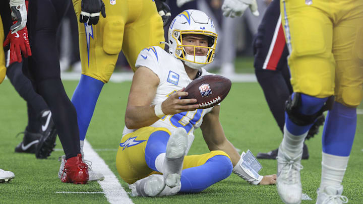 Jan 11, 2025; Houston, Texas, USA; Los Angeles Chargers quarterback Justin Herbert (10) reacts after being sacked during the game against the Houston Texans in an AFC wild card game at NRG Stadium. Mandatory Credit: Troy Taormina-Imagn Images