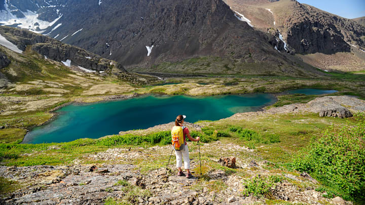 A backpacker enjoys the view in Chugach State Park near Anchorage, Alaska.