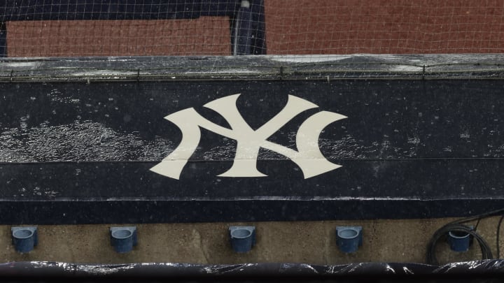 Aug 17, 2020; Bronx, New York, USA; A general view of rain falling on the New York Yankees logo on the first base dugout roof during a rain delay in the game between the New York Yankees and the Boston Red Sox. Mandatory Credit: Vincent Carchietta-USA TODAY Sports Aug 17, 2020; Bronx, New York, USA; A general view of rain falling on the New York Yankees logo on the first base dugout roof during a rain delay in the game between the New York Yankees and the Boston Red Sox. Mandatory Credit: Vincent Carchietta-USA TODAY Sports