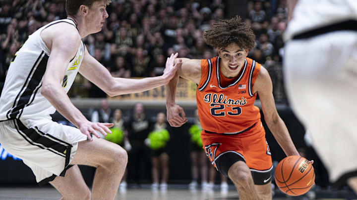 Jan 24, 2026; West Lafayette, Indiana, USA; Illinois Fighting Illini guard Keaton Wagler (23) dribbles past Purdue Boilermakers center Daniel Jacobsen (12) during the first half at Mackey Arena. Mandatory Credit: Jacob Musselman-Imagn Images