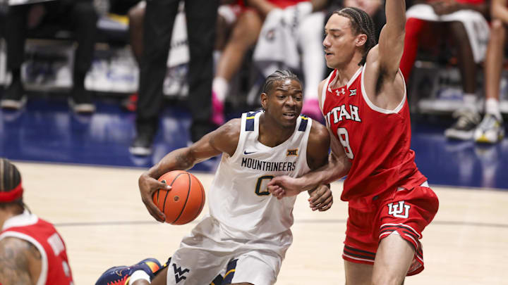 Feb 18, 2026; Morgantown, West Virginia, USA; West Virginia Mountaineers forward Brenen Lorient (0) drives down the lane against Utah Utes forward Keanu Dawes (8) during the first half at Hope Coliseum. 