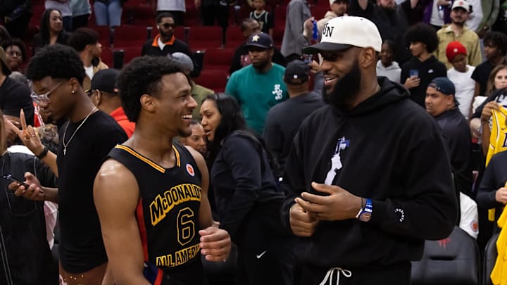 Mar 28, 2023; Houston, TX, USA; West guard Bronny James (6) with father LeBron James following the
