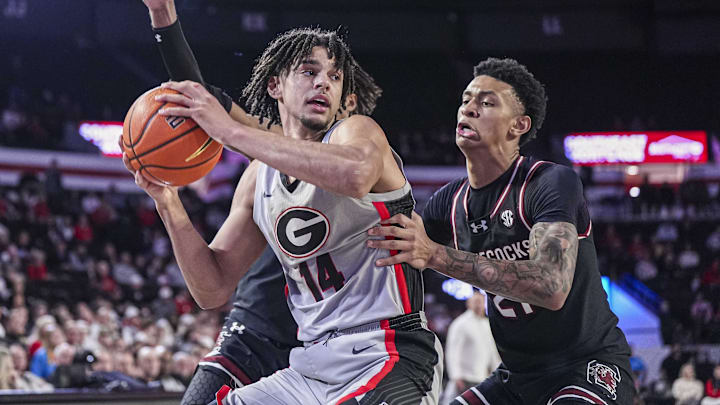 Jan 28, 2025; Athens, Georgia, USA; Georgia Bulldogs forward Asa Newell (14) controls the ball in front of South Carolina Gamecocks guard Arden Conyers (21) during the second half at Stegeman Coliseum. Mandatory Credit: Dale Zanine-Imagn Images