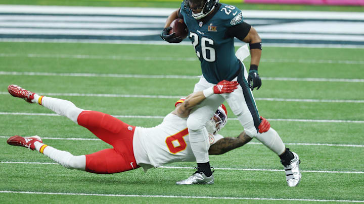 Feb 9, 2025; New Orleans, LA, USA; Philadelphia Eagles running back Saquon Barkley (26) runs the ball against Kansas City Chiefs safety Bryan Cook (6) in the first quarter in Super Bowl LIX at Ceasars Superdome. Mandatory Credit: Stephen Lew-Imagn Images