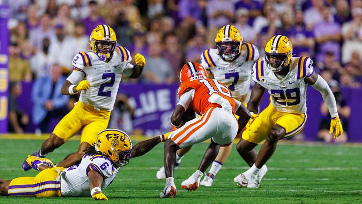 Clemson Tigers running back Chris Johnson Jr. (16) runs the ball against LSU Tigers linebacker TJ Dottery (6) , defensive end Jordan Ross (29) and linebacker Whit Weeks (7) during the first half at Tiger Stadium. Mandatory Credit: Stephen Lew-Imagn Images Clemson Tigers running back Chris Johnson Jr. (16) runs the ball against LSU Tigers linebacker TJ Dottery (6) , defensive end Jordan Ross (29) and linebacker Whit Weeks (7) during the first half at Tiger Stadium. Mandatory Credit: Stephen Lew-Imagn Images