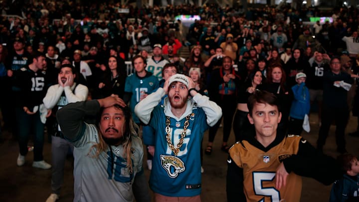 Jacksonville Jaguars fans, from left, Griffin Lasch, Garrett Roberson, and Gabriel Mont react to