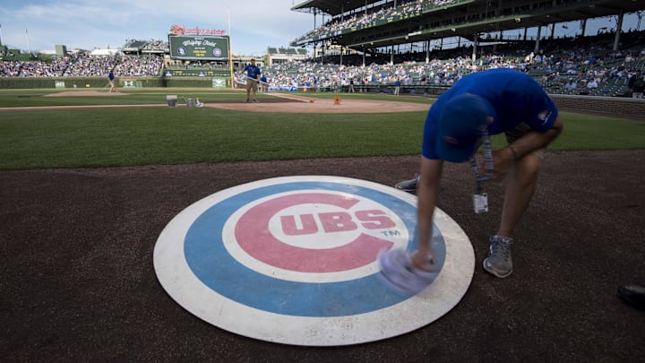 Jun 19, 2017; Chicago, IL, USA; A member of the grounds crew wipes off the Chicago Cubs' on deck logo prior to a game against the San Diego Padres at Wrigley Field. Mandatory Credit: Patrick Gorski-Imagn Images Jun 19, 2017; Chicago, IL, USA; A member of the grounds crew wipes off the Chicago Cubs' on deck logo prior to a game against the San Diego Padres at Wrigley Field. Mandatory Credit: Patrick Gorski-Imagn Images