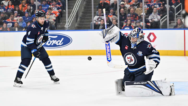 Dec 6, 2025; Edmonton, Alberta, CAN; Winnipeg Jets defenseman Dylan DeMelo (4) watches Winnipeg Jets goalie Thomas Milic (32) reach for the puck as they took on the Edmonton Oilers during the third period at Rogers Place. Mandatory Credit: Walter Tychnowicz-Imagn Images Dec 6, 2025; Edmonton, Alberta, CAN; Winnipeg Jets defenseman Dylan DeMelo (4) watches Winnipeg Jets goalie Thomas Milic (32) reach for the puck as they took on the Edmonton Oilers during the third period at Rogers Place. Mandatory Credit: Walter Tychnowicz-Imagn Images