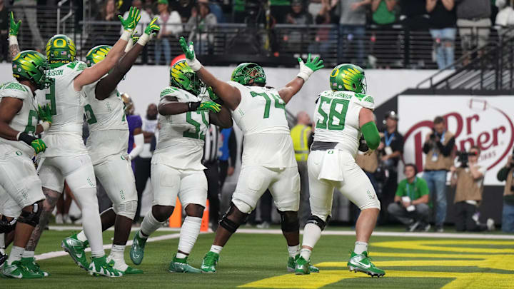 Dec 1, 2023; Las Vegas, NV, USA; Oregon Ducks offensive linemen Jackson Powers-Johnson (58) and squad celebrate in the endzone.
