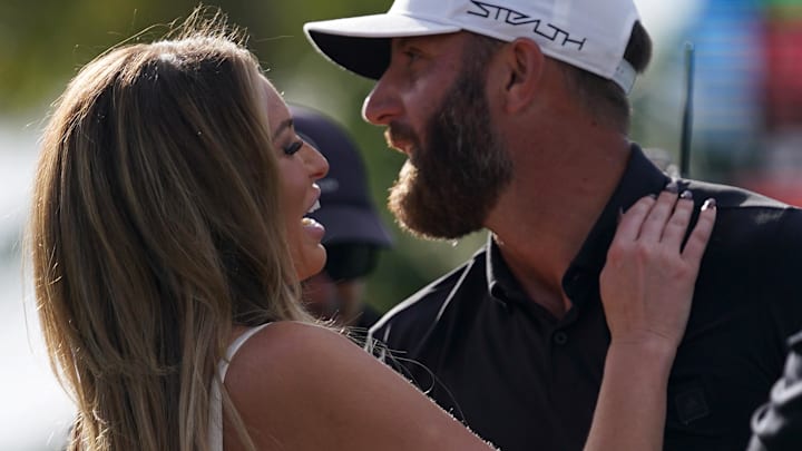 Dustin Johnson embraces his wife Paulina Gretzky (L) after winning. Dustin Johnson embraces his wife Paulina Gretzky (L) after winning.