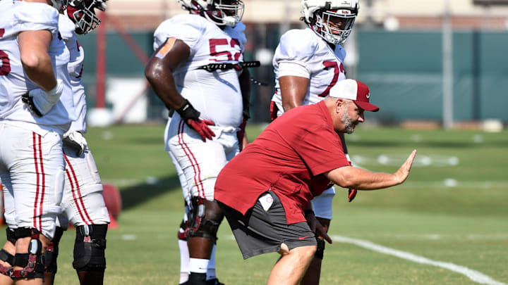 The Crimson Tide players and coaches continue working toward the season opener in practice Tuesday, Aug. 13, 2024. Alabama offensive line coach Chris Kapilovic directs his linemen.
