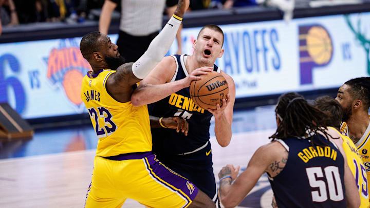 Apr 29, 2024; Denver, Colorado, USA; Denver Nuggets center Nikola Jokic (15) drives to the net against Los Angeles Lakers forward LeBron James (23) in the fourth quarter during game five of the first round for the 2024 NBA playoffs at Ball Arena. Mandatory Credit: Isaiah J. Downing-Imagn Images