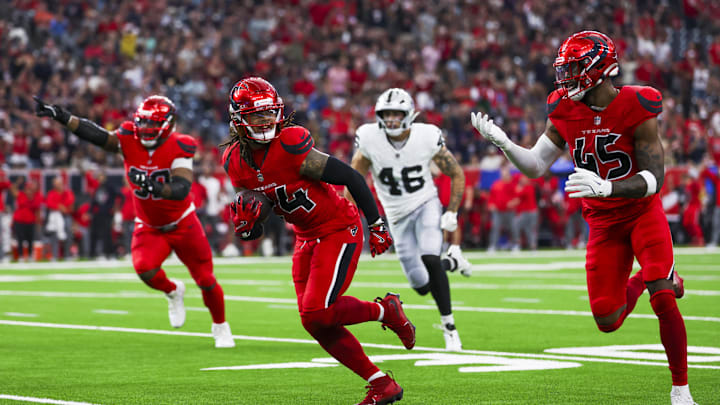 Dec 21, 2025; Houston, Texas, USA; Houston Texans cornerback Derek Stingley Jr. (24) returns an interception for a touchdown against the Las Vegas Raiders during the first quarter at NRG Stadium. Houston Texans linebacker E.J. Speed (45) follows Stingley Jr. at left. Mandatory Credit: Thomas Shea-Imagn Images