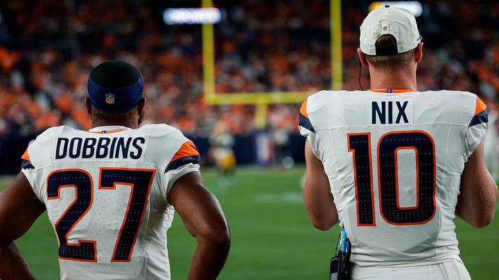 Denver Broncos running back J.K. Dobbins (27) and quarterback Bo Nix (10) look on in the third quarter against the Green Bay Packers at Empower Field at Mile High. Denver Broncos running back J.K. Dobbins (27) and quarterback Bo Nix (10) look on in the third quarter against the Green Bay Packers at Empower Field at Mile High.