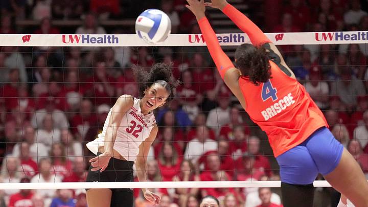 Wisconsin outside hitter Grace Egan (32) hits the ball past Florida middle blocker Brooklyn Briscoe (4) during their match Wednesday, Sept. 2, 2026 at the UW Field House in Madison, Wisconsin.