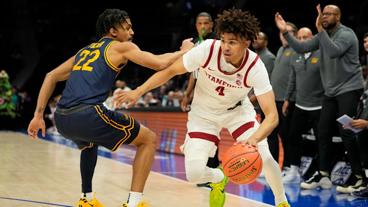 Mar 12, 2025; Charlotte, NC, USA; Stanford Cardinal guard Oziyah Sellers (4) with the ball as California Golden Bears guard Christian Tucker (22) defends in the first half at Spectrum Center. Mandatory Credit: Bob Donnan-Imagn Images Mar 12, 2025; Charlotte, NC, USA; Stanford Cardinal guard Oziyah Sellers (4) with the ball as California Golden Bears guard Christian Tucker (22) defends in the first half at Spectrum Center. Mandatory Credit: Bob Donnan-Imagn Images