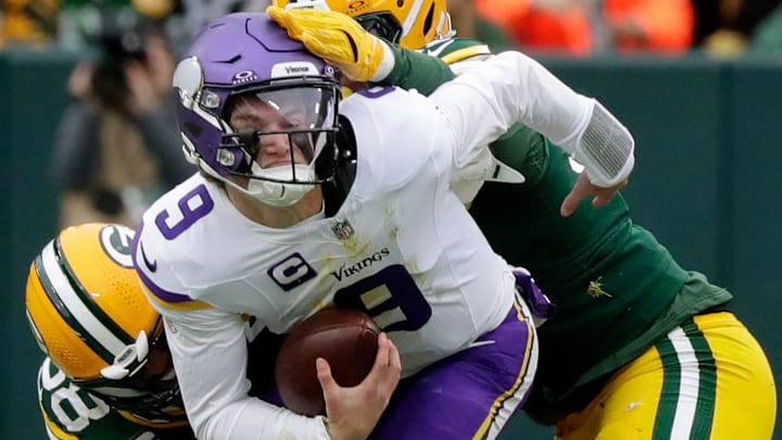 Green Bay Packers linebacker Isaiah McDuffie (58) and defensive tackle Warren Brinson (91) sack Minnesota Vikings quarterback J.J. McCarthy (9) on Sunday, November 23, 2025, at Lambeau Field in Green Bay, Wis. The Packers defeated the Vikings 23-6.