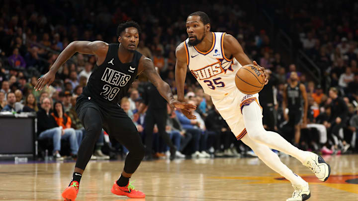 Dec 13, 2023; Phoenix, Arizona, USA; Phoenix Suns forward Kevin Durant (35) against Brooklyn Nets forward Dorian Finney-Smith (28) at Footprint Center. Mandatory Credit: Mark J. Rebilas-Imagn Images