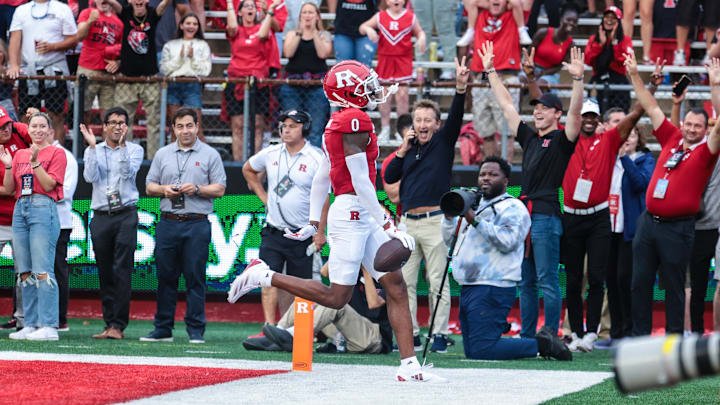 Aug 29, 2024; Piscataway, New Jersey, USA; Rutgers Scarlet Knights defensive back Eric Rogers (0) runs back an interception for a touchdown during the first half against the Howard Bison at SHI Stadium. Mandatory Credit: Vincent Carchietta-Imagn Images