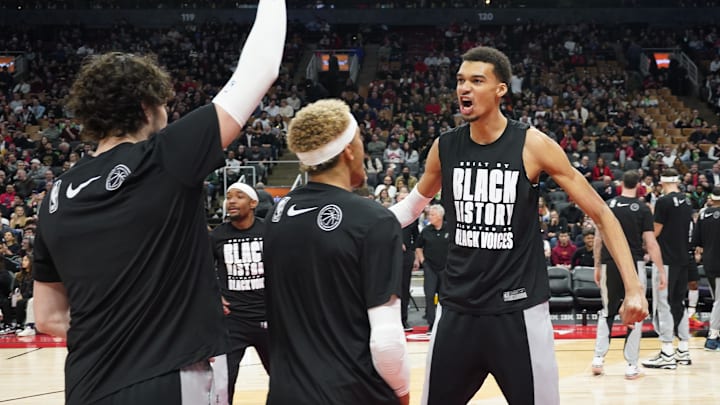 Feb 12, 2024; Toronto, Ontario, CAN; San Antonio Spurs center Victor Wembanyama (right) reacts as he comes out for player introductions before a game against the Toronto Raptors at Scotiabank Arena.