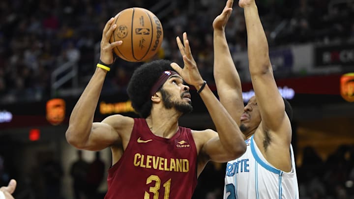 Mar 25, 2024; Cleveland, Ohio, USA; Cleveland Cavaliers center Jarrett Allen (31) shoots beside Charlotte Hornets forward Grant Williams (2) in the second quarter at Rocket Mortgage FieldHouse. Mandatory Credit: David Richard-Imagn Images