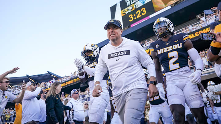 Sep 7, 2024; Columbia, Missouri, USA; Missouri Tigers head coach Eli Drinkwitz runs out with the team against the Buffalo Bulls prior to a game at Faurot Field at Memorial Stadium. Sep 7, 2024; Columbia, Missouri, USA; Missouri Tigers head coach Eli Drinkwitz runs out with the team against the Buffalo Bulls prior to a game at Faurot Field at Memorial Stadium.
