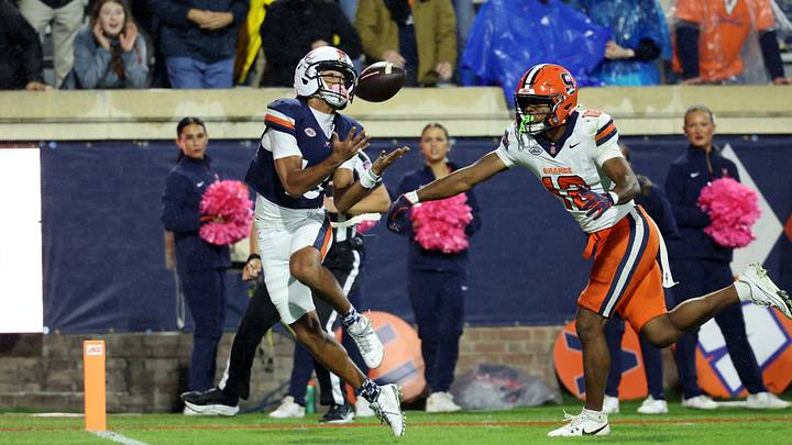 Oct 10, 2026; Charlottesville, Virginia, USA; Virginia Cavaliers wide receiver Da'shawn Martin (18)* catches a touchdown pass as Syracuse Orange defensive back Chris Peal (12) defends in the third quarter at Scott Stadium. Mandatory Credit: Geoff Burke-Imagn Images