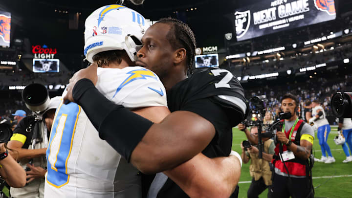 Sep 15, 2025; Paradise, Nevada, USA; Las Vegas Raiders quarterback Geno Smith (7) greets Los Angeles Chargers quarterback Justin Herbert (10) after the game at Allegiant Stadium. Mandatory Credit: Kiyoshi Mio-Imagn Images
