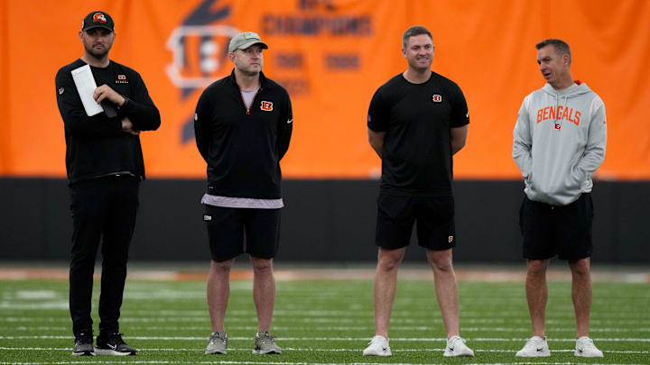 From left: Director of College Scouting Mike Potts, Director of Player Personnel Duke Tobin, head coach Zac Taylor and defensive coordinator Lou Anarumo talk as rookies stretch during the team   s mini rookie camp, Friday, May 12, 2023, inside the team   s indoor practice bubble in Cincinnati.