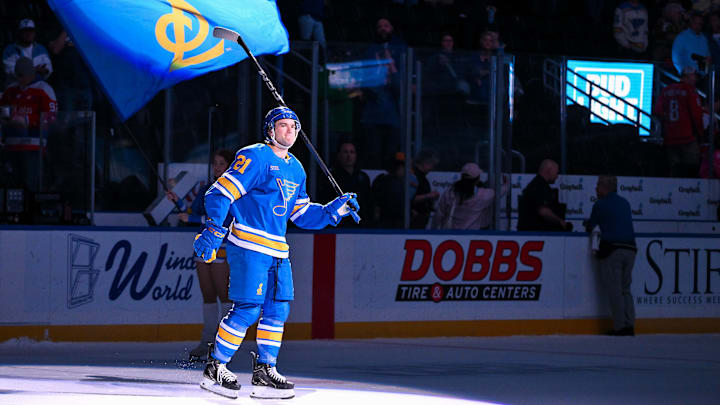 Mar 24, 2026; St. Louis, Missouri, USA; St. Louis Blues right wing Jimmy Snuggerud (21) salutes the fans after he was named second star of the game after a victory over the Washington Capitals at Enterprise Center. Mandatory Credit: Jeff Curry-Imagn Images