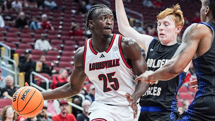 Louisville Cardinals forward Aboubacar Traore (25) looks to pass around Spalding University's Caden Bradford (0) at the KFC Yum! Center in Louisville, Kentucky Monday, Oct. 28, 2024.