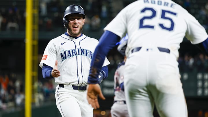 Seattle Mariners pinch hitter Miles Mastrobuoni (left) reacts after scoring a run against the Houston Astros on April 7 at T-Mobile Park.