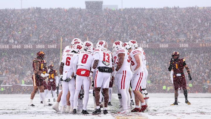 Nov 29, 2025; Minneapolis, Minnesota, USA; Wisconsin Badgers players huddle during the first half against the Minnesota Golden Gophers at Huntington Bank Stadium. Mandatory Credit: Matt Krohn-Imagn Images Nov 29, 2025; Minneapolis, Minnesota, USA; Wisconsin Badgers players huddle during the first half against the Minnesota Golden Gophers at Huntington Bank Stadium. Mandatory Credit: Matt Krohn-Imagn Images