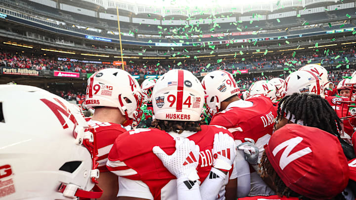 Nebraska players, including No. 94 Jordan Ochoa, celebrate the Huskers' victory over Boston College in the 2024 Pinstripe Bowl.