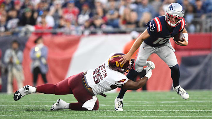 Aug 8, 2025; Foxborough, Massachusetts, USA; Washington Commanders safety Dominique Hampton (45) tackles New England Patriots quarterback Drake Maye (10) during the first half at Gillette Stadium. Mandatory Credit: Brian Fluharty-Imagn Images