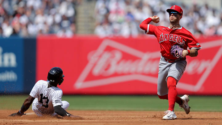 Jun 19, 2025; Bronx, New York, USA; Los Angeles Angels shortstop Zach Neto (9) forces out New York Yankees second baseman Jazz Chisholm Jr. (13) at second base and throws to first to attempt a double play on a ball hit by Yankees shortstop Anthony Volpe (not pictured) during the sixth inning at Yankee Stadium. Volpe was safe at first base. Mandatory Credit: Brad Penner-Imagn Images