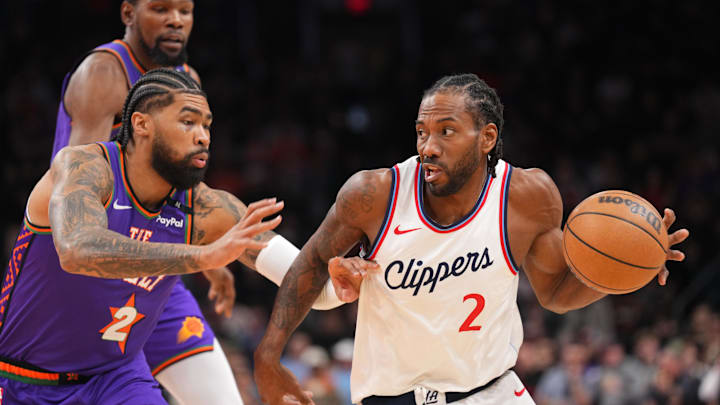 Mar 4, 2025; Phoenix, Arizona, USA; LA Clippers forward Kawhi Leonard (2) dribbles against Phoenix Suns center Nick Richards (2) during the first half at PHX Center. Mandatory Credit: Joe Camporeale-Imagn Images