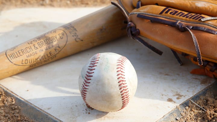 Home plate, a ball and a glove. 