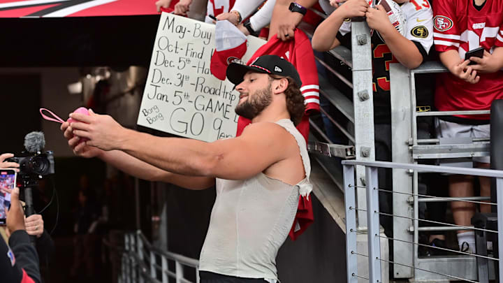 Jan 5, 2025; Glendale, Arizona, USA; San Francisco 49ers defensive end Nick Bosa (97) takes a selfie for a fan prior to the game against the Arizona Cardinals at State Farm Stadium. Mandatory Credit: Matt Kartozian-Imagn Images Jan 5, 2025; Glendale, Arizona, USA; San Francisco 49ers defensive end Nick Bosa (97) takes a selfie for a fan prior to the game against the Arizona Cardinals at State Farm Stadium. Mandatory Credit: Matt Kartozian-Imagn Images