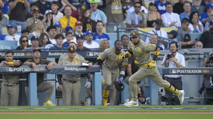 Oct 5, 2024; Los Angeles, California, USA; San Diego Padres first baseman Luis Arraez (4) hits a single in the first inning against the Los Angeles Dodgers during game one of the NLDS for the 2024 MLB Playoffs at Dodger Stadium. Mandatory Credit: Jayne Kamin-Oncea-Imagn Images