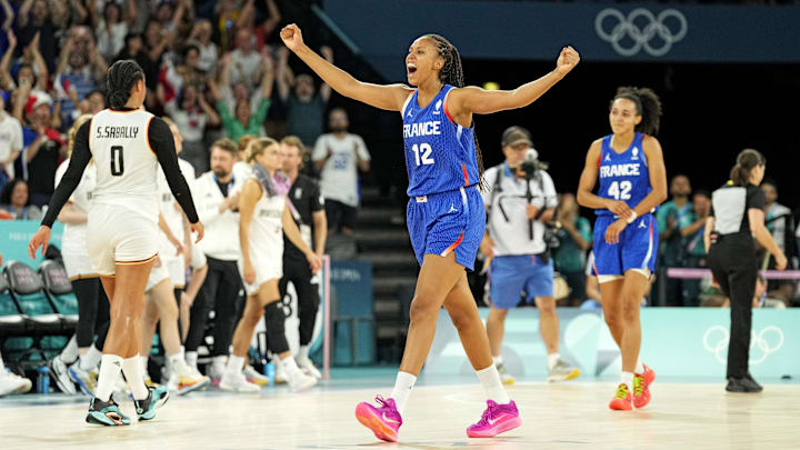 Aug 7, 2024; Paris, France; France centre Iliana Rupert (12) celebrates after defeating Germany in the women’s basketball quarterfinals during the Paris 2024 Olympic Summer Games at Accor Arena. Mandatory Credit: Kyle Terada-Imagn Images