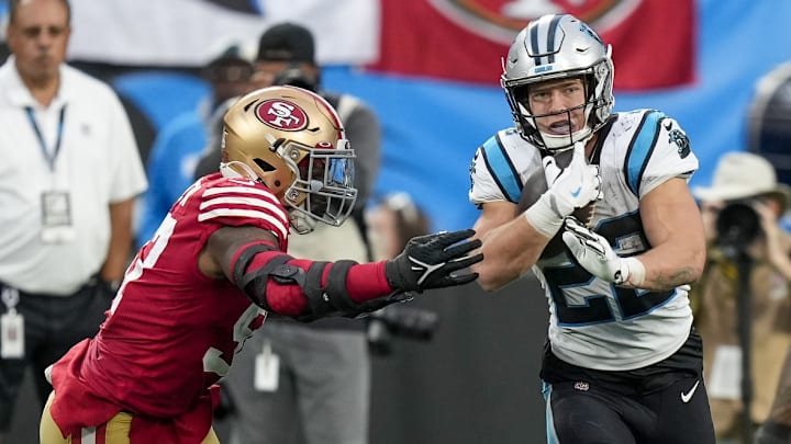 Oct 9, 2022; Charlotte, North Carolina, USA; Carolina Panthers running back Christian McCaffrey (22) tries to elude San Francisco 49ers defensive end Kemoko Turay (53) during the second half at Bank of America Stadium.