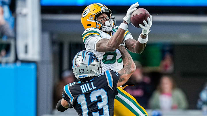 Dec 24, 2023; Charlotte, North Carolina, USA; Green Bay Packers wide receiver Romeo Doubs (87) against Carolina Panthers cornerback Troy Hill (13) during the second half at Bank of America Stadium. 
