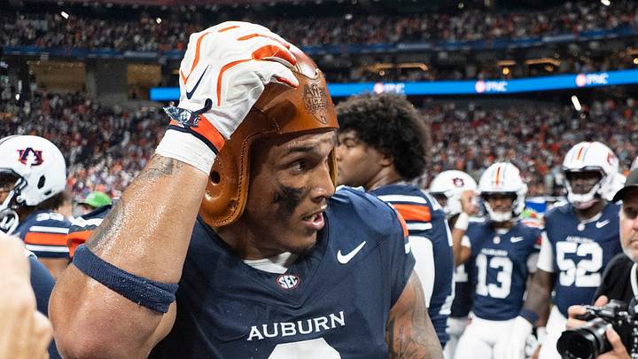 Auburn Tigers linebacker Elijah Melendez (9) celebrates with the Old Leather Helmet Trophy as Auburn Tigers take on Baylor Bears in the Aflac Kickoff Game at Mercedes-Benz Stadium in Atlanta, Ga. on Saturday, Sept. 5, 2026. Auburn Tigers defeated Baylor Bears 17-16.