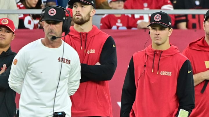 Jan 5, 2025; Glendale, Arizona, USA;  San Francisco 49ers quarterback Brock Purdy (right) and head coach Kyle Shanahan (left) look on the in second half against the Arizona Cardinals at State Farm Stadium. Mandatory Credit: Matt Kartozian-Imagn Images